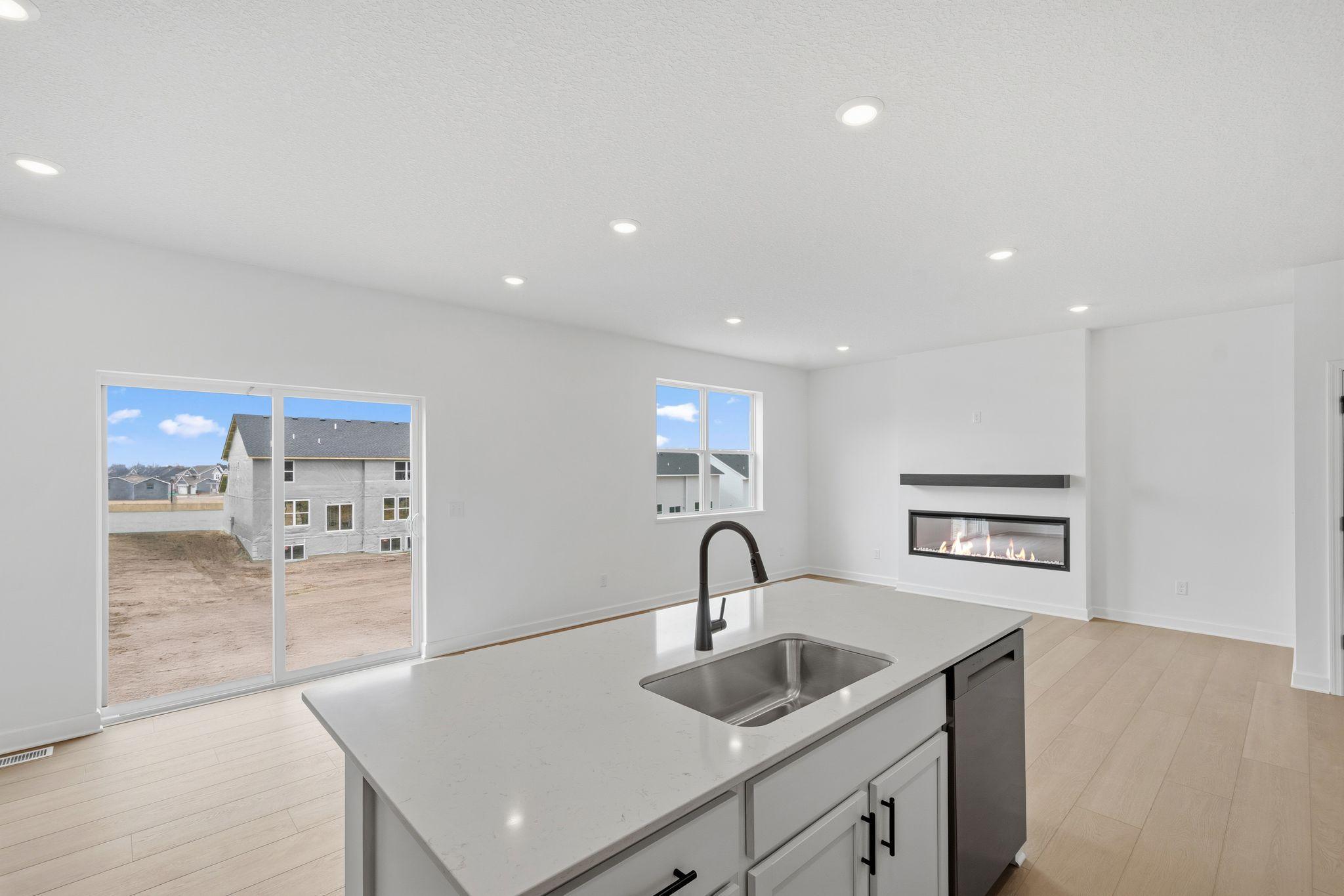 (Photo of a similar home, actual finishes may vary) The kitchen overlooks the dining room in this open floorplan
