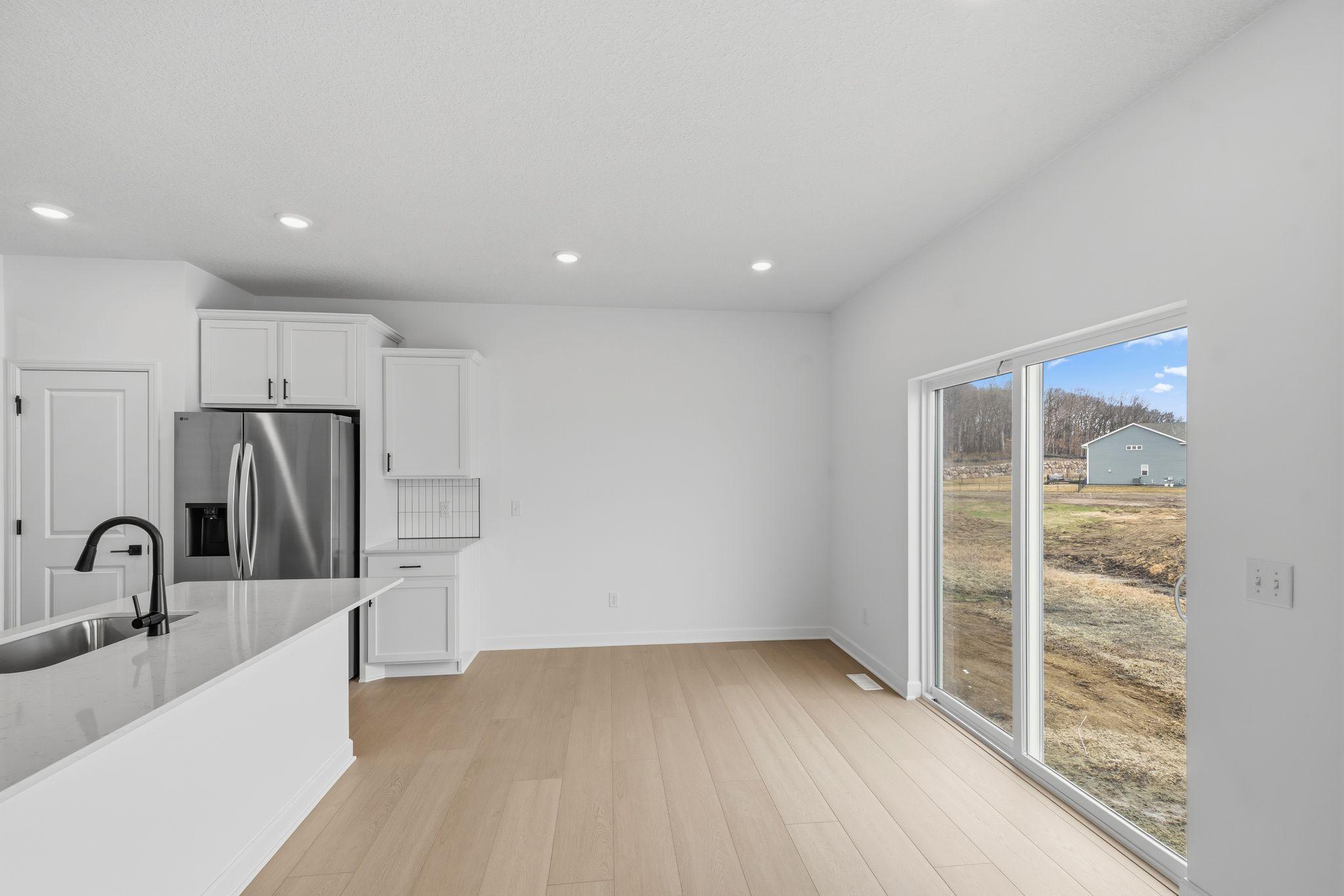 (Photo of a similar home, actual finishes may vary) Conveniently located just steps away from the kitchen, the dining room is perfect for entertaining and having meals with friends and family.