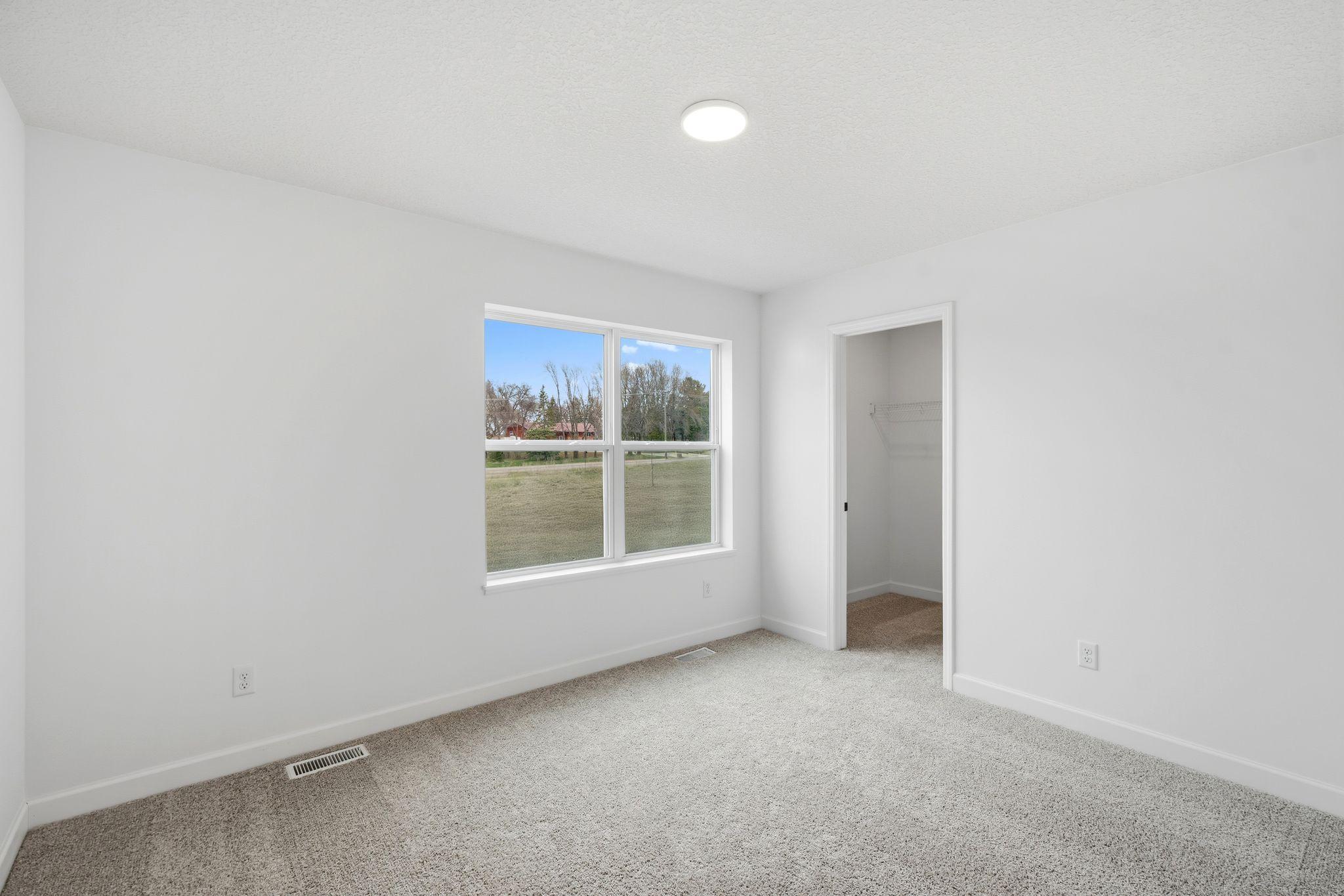 (Photo of a similar home, actual finishes may vary) Complete with a large bedroom, en-suite bathroom and walk-in closet, the luxurious owner’s suite is tucked away on the second level for enhanced privacy.