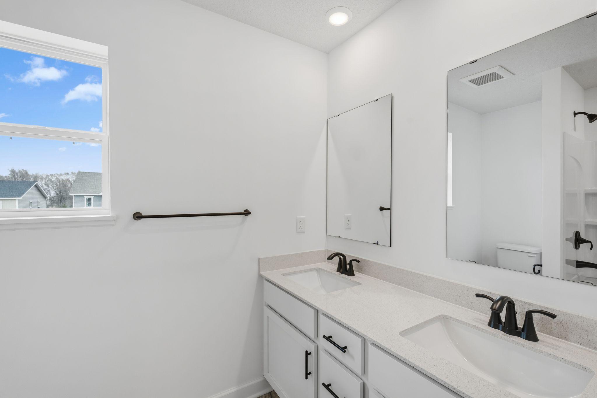 (Photo of a similar home, actual finishes may vary) The en-suite bathroom provides a spa-inspired experience
