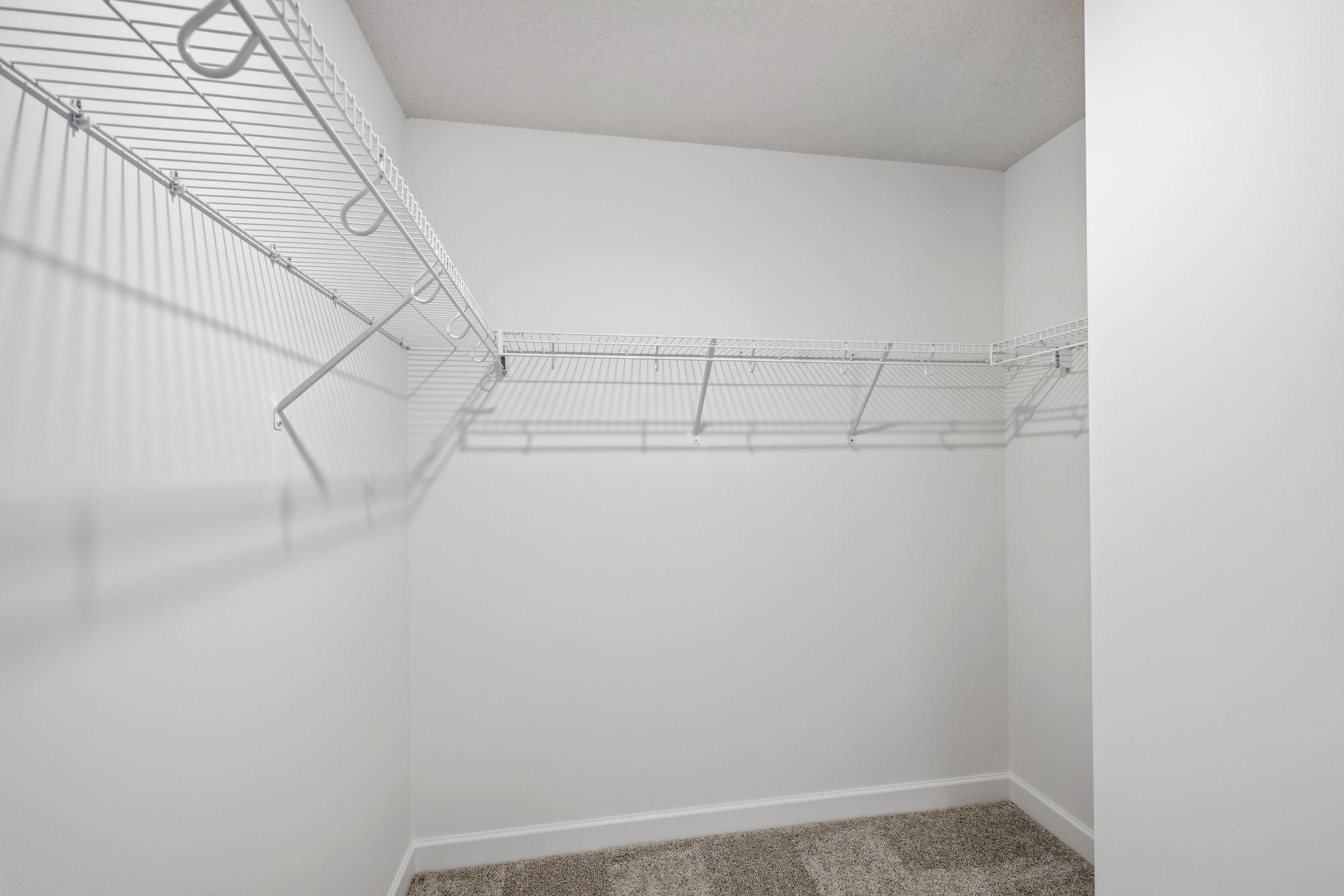 (Photo of a similar home, actual finishes may vary) The walk-in closet offers ample space