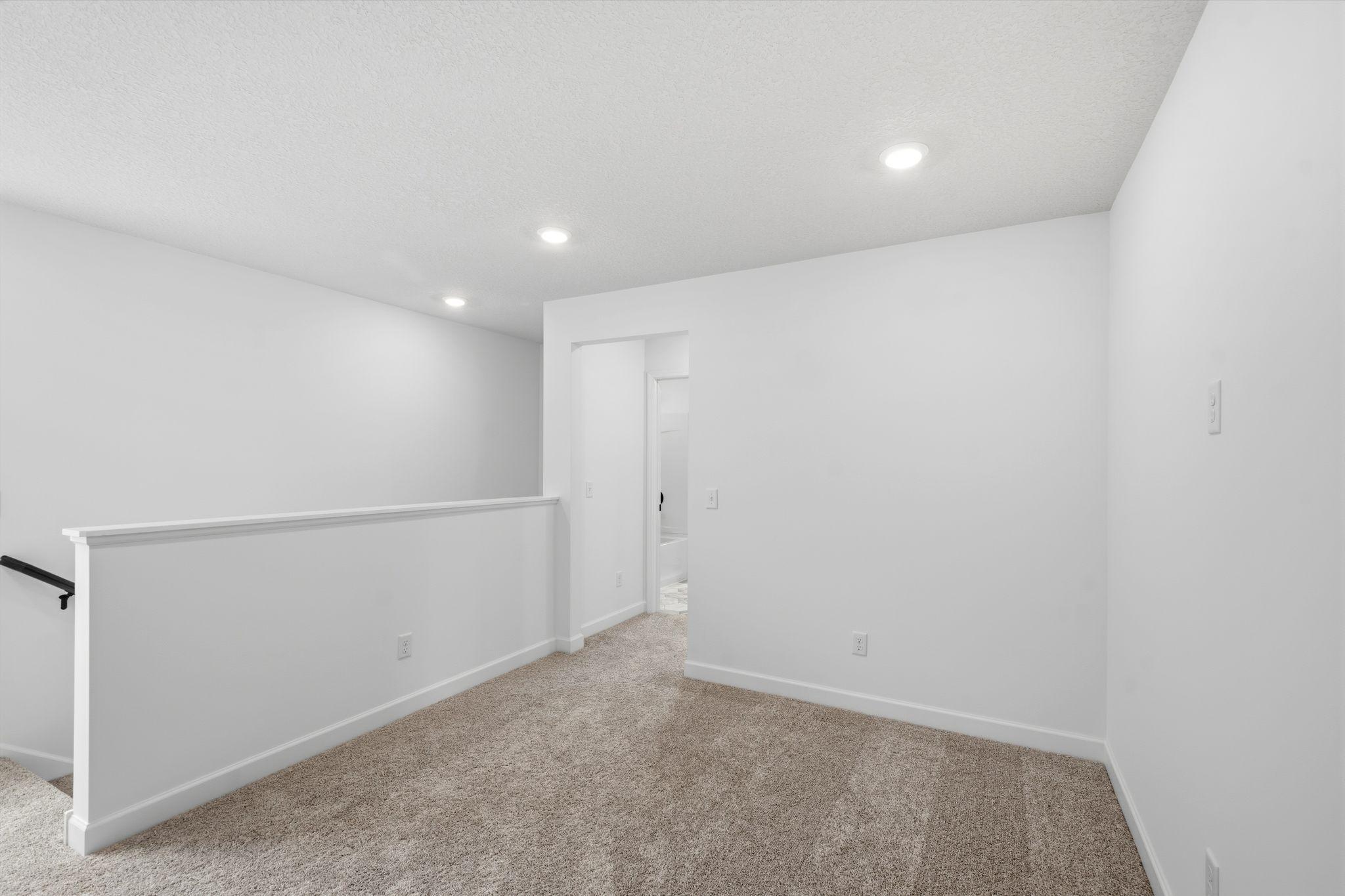 (Photo of a similar home, actual finishes may vary) Found at the top of the stairs, the loft is a versatile space and can be used as an additional living area or home office.