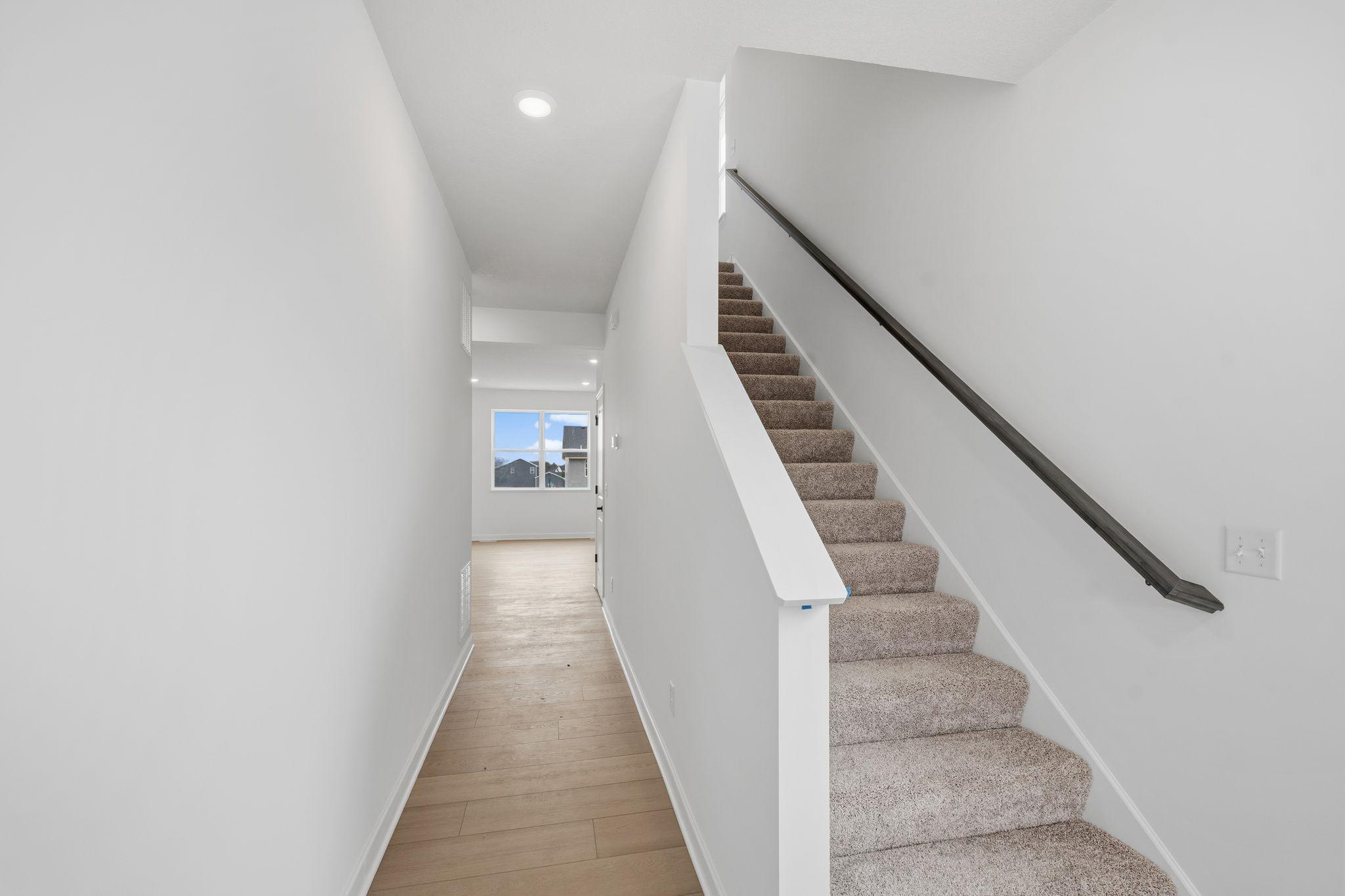 (Photo of a similar home, actual finishes may vary) The foyer gives you a preview of all the natural light offered throughout the home