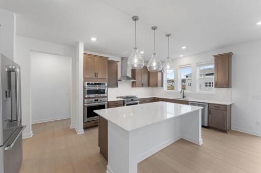 A modern kitchen creates a functional and stylish space to create chef-inspired meals with sleek cabinetry and brand-new stainless steel appliances.