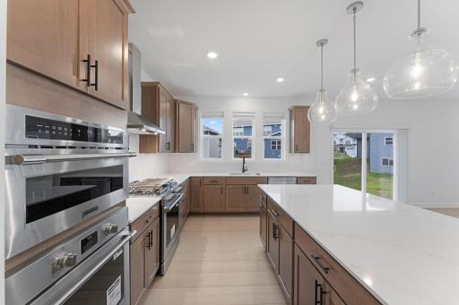 The generous center island is ready for meal prep or casual meals at the breakfast bar