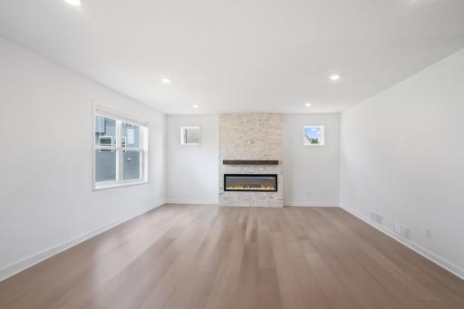 The living room is designed as the premier gathering spot in the heart of the home with easy access to surrounding spaces within the open floorplan.