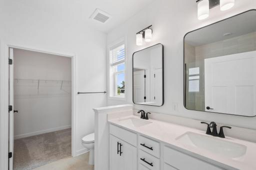 Double sinks and twin mirrors complement busy lifestyles in the en-suite bathroom