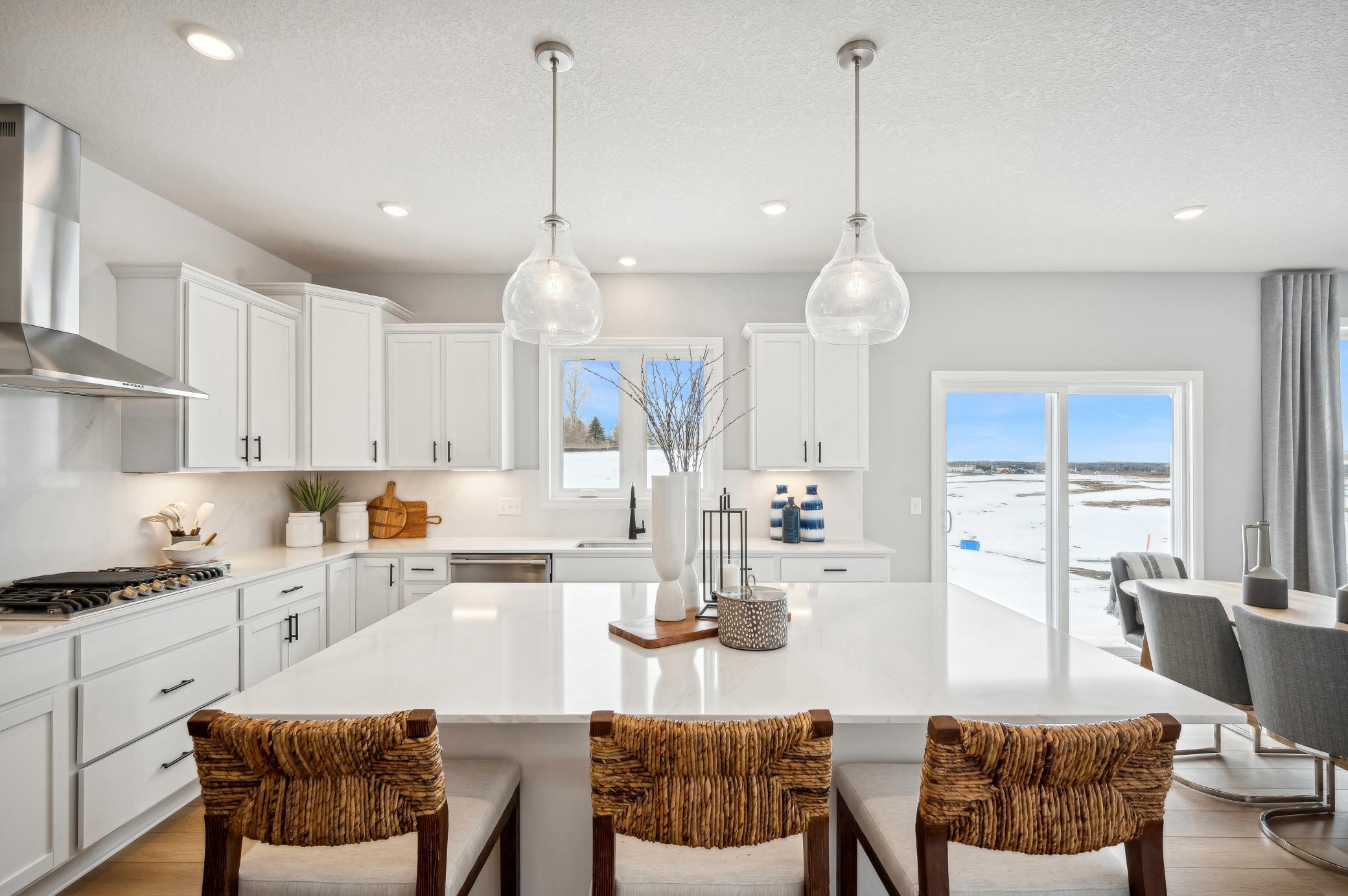 (Photo of model home, finishes will vary) Enjoy plenty of seating at the kitchen island and dining area adjacent to the kitchen. Perfect for entertaining or having a family meal together.