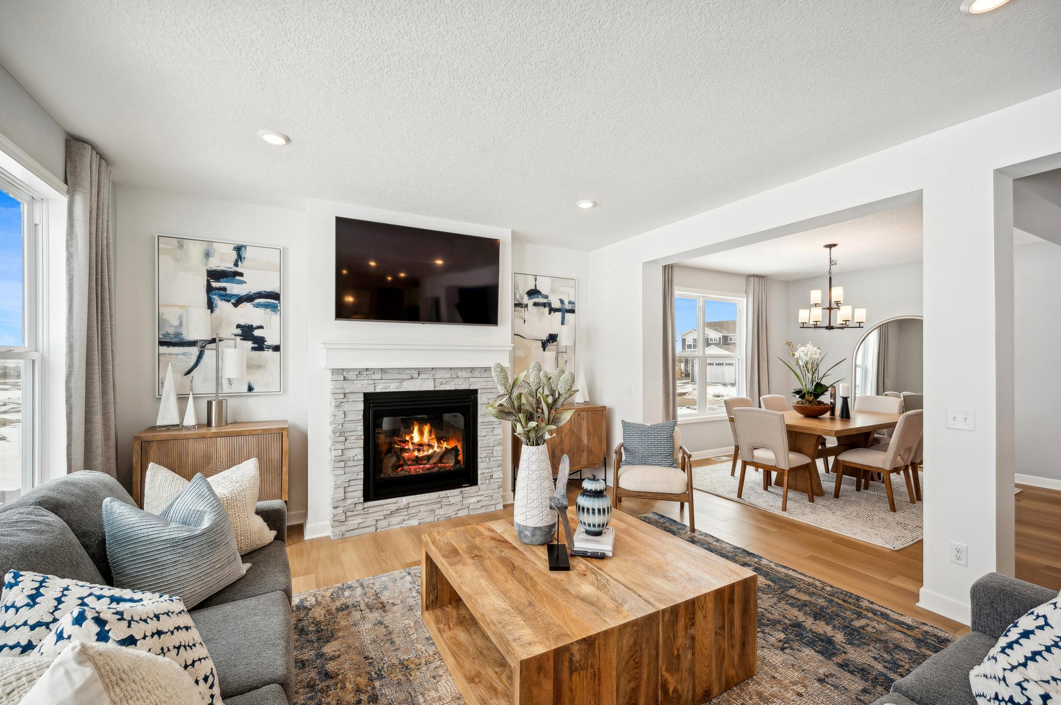 (Photo of model home, finishes will vary) The spacious family gathering area seamlessly connects to the kitchen area, perfect for entertaining. It also features many large windows providing warm natural light.