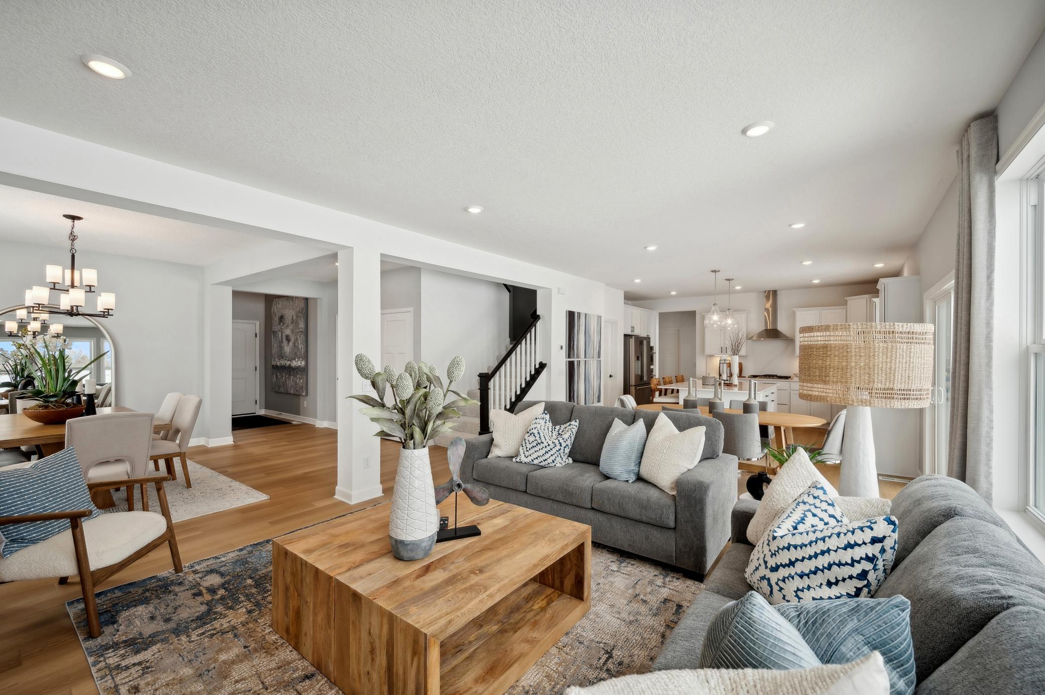 (Photo of model home, finishes will vary) A wall of windows in the Great Room offer a sunlit view of the neighborhood and brighten daytime gatherings. It’s an ideal space for relaxing and enjoying the company of loved ones.