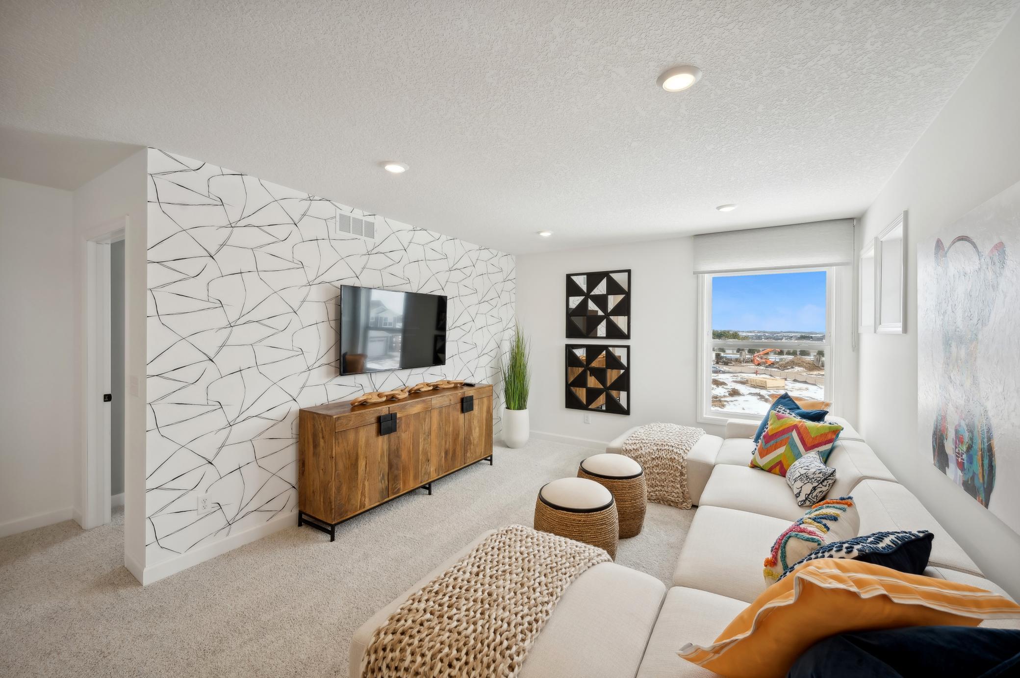 (Photo of model home, finishes will vary) Located on the upper level, this perfectly sized living space has enough room for a desk, television and seating for all. Plus, it is just steps away from all the bedrooms.