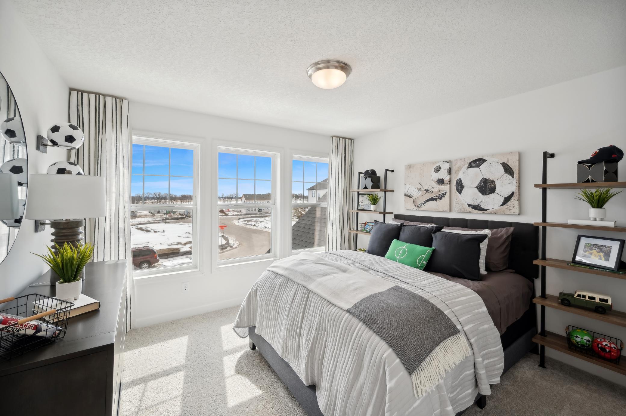 (Photo of model home, finishes will vary) One of three generously sized upper level secondary bedroom with a spacious closet.