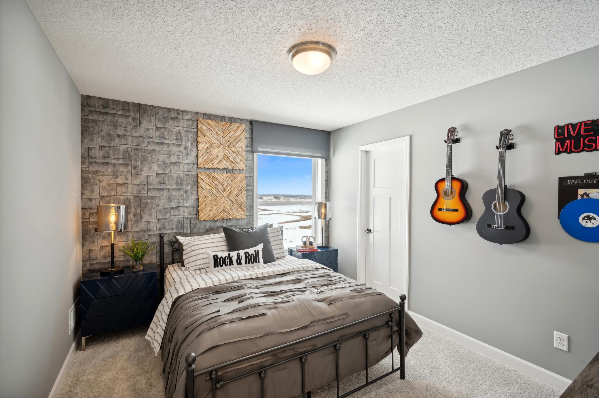 (Photo of model home, finishes will vary) One of three generously sized upper level secondary bedroom with a spacious closet.