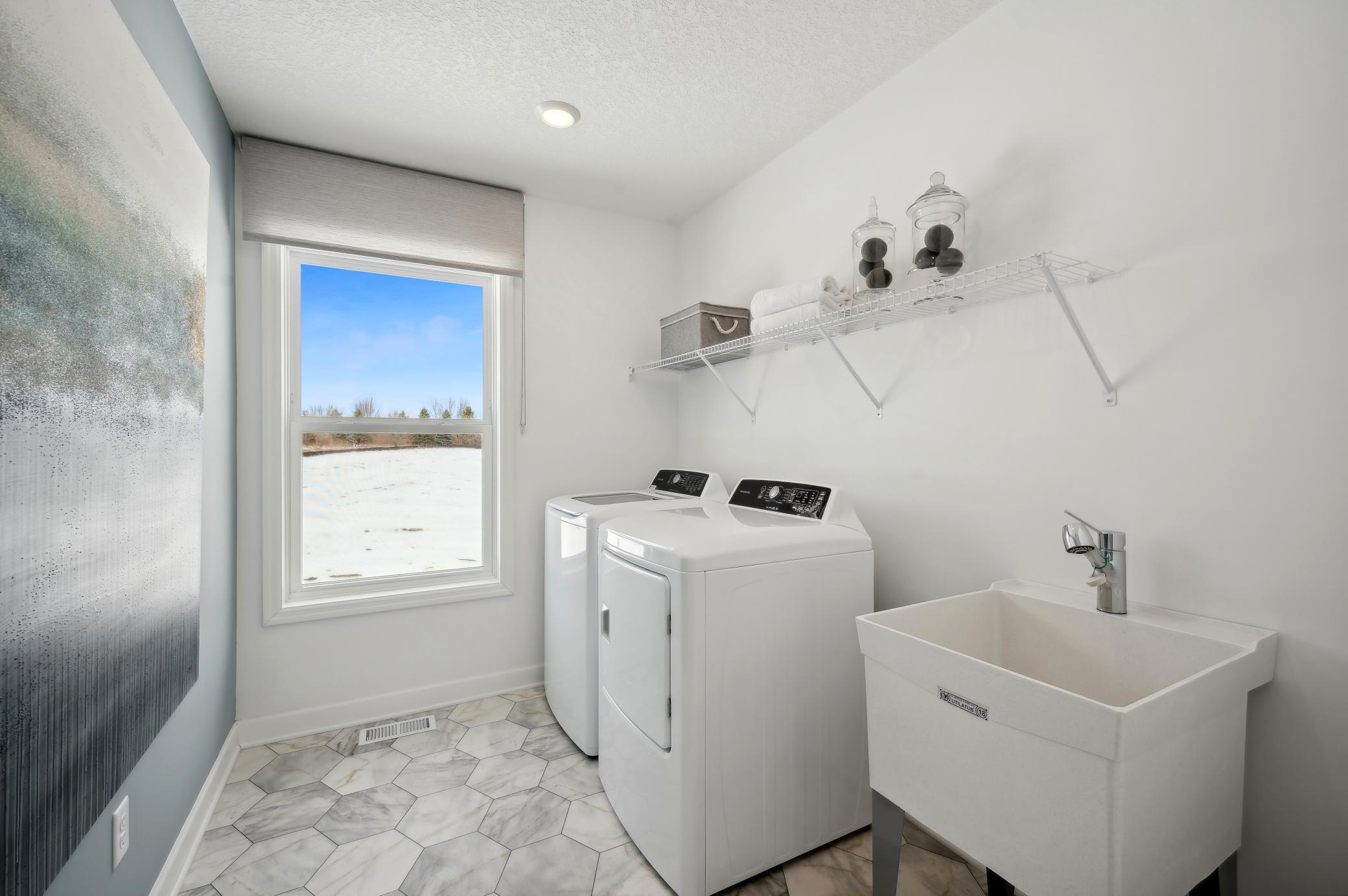 (Photo of model home, finishes will vary) Sick of carrying laundry all over the home? Conveniently located on the second level, this plan features upper-level laundry right next to the home's five bedrooms.
