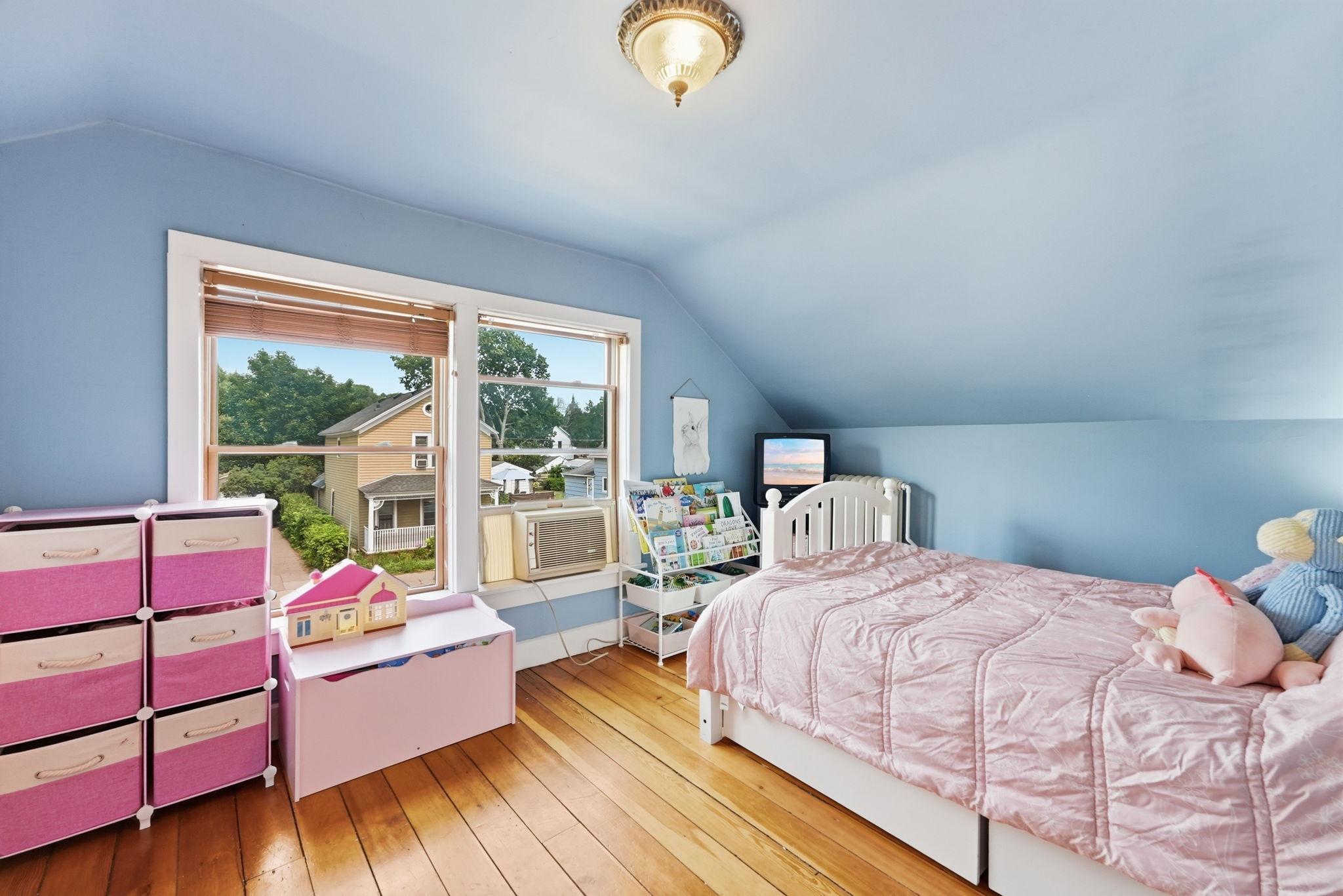 Upper level bedroom with a wall of windows.