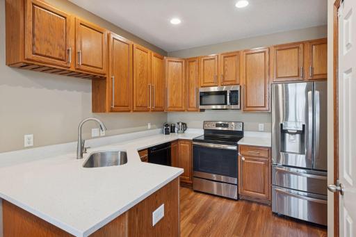 new stone countertops in the kitchen and stainless steel appliances
