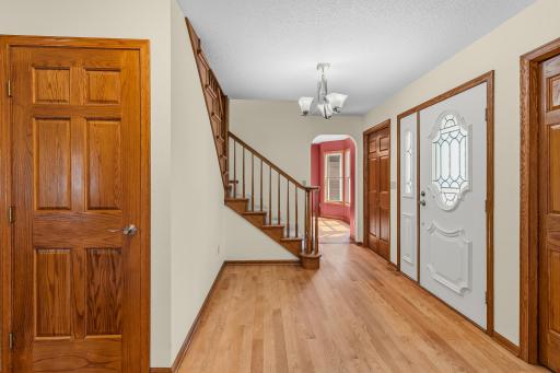 Main level front entry featuring hardwood floors & open staircase !