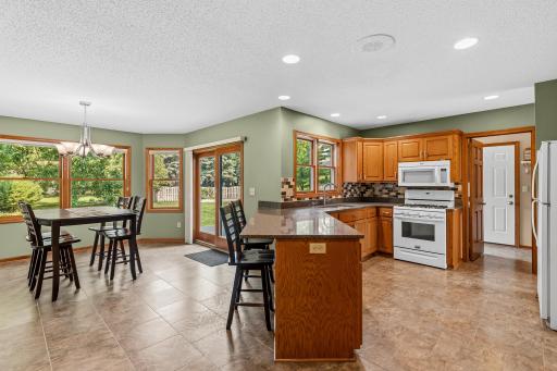 large bright kitchen with addition leading out to the back deck & patio !