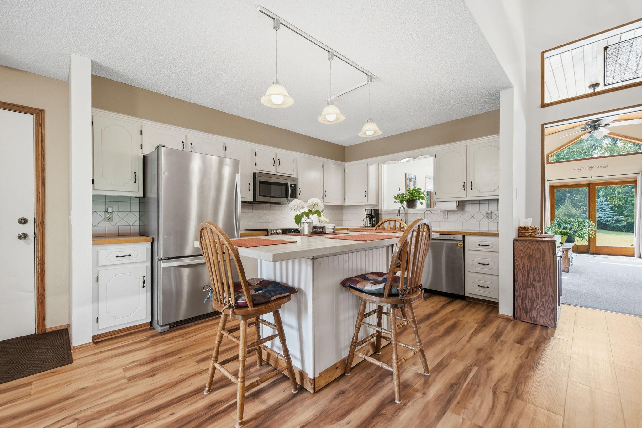 Kitchen features a center island and stainless appliances!