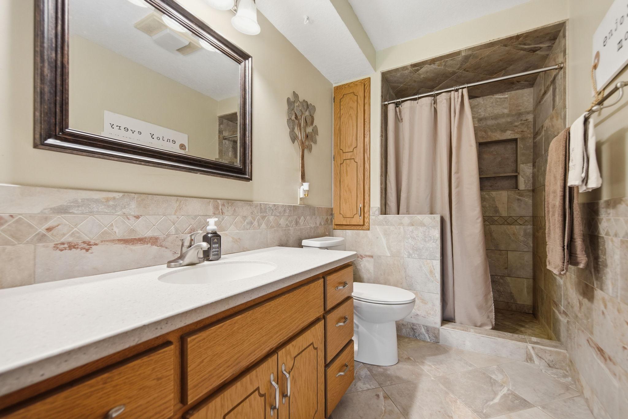 Updated 3rd level 3/4 bathroom with in floor heat and custom ceramic tile.