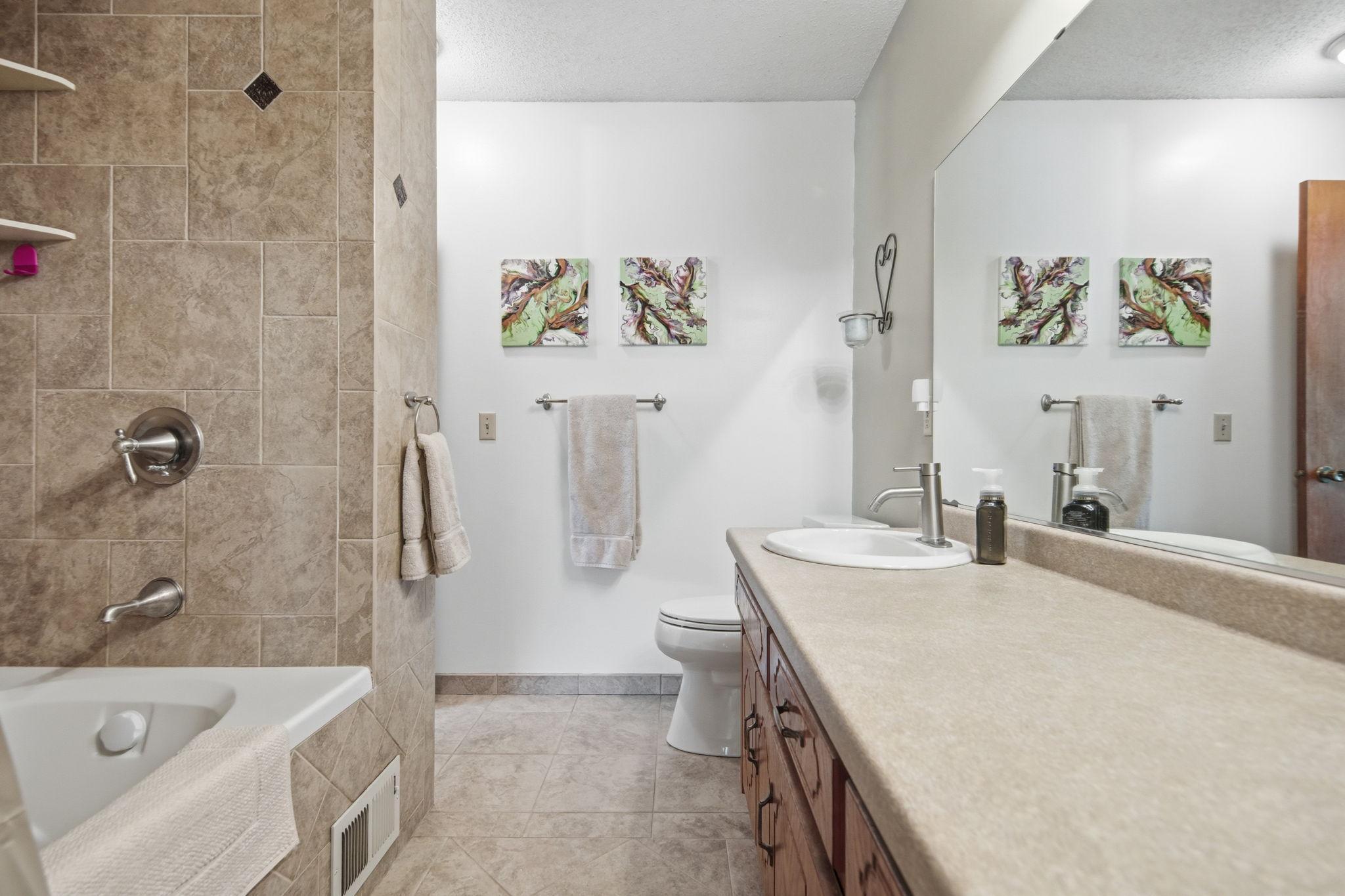 Upper level full bathroom with custom ceramic tile.