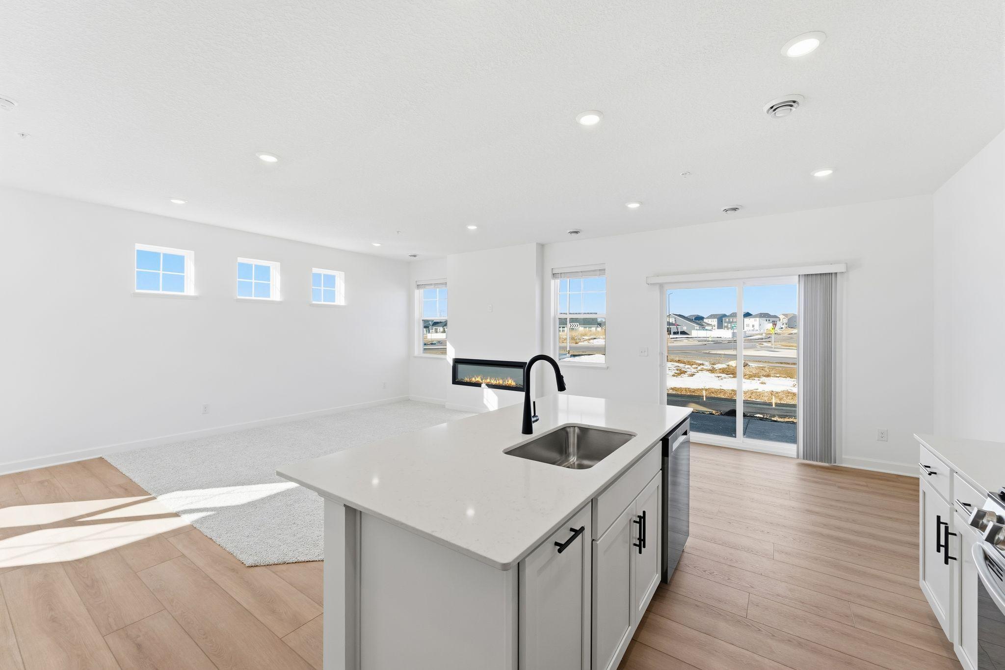 (Photo of a similar home, actual finishes may vary) This center island includes a stainless steel sink with designer faucet to remove stubborn stains