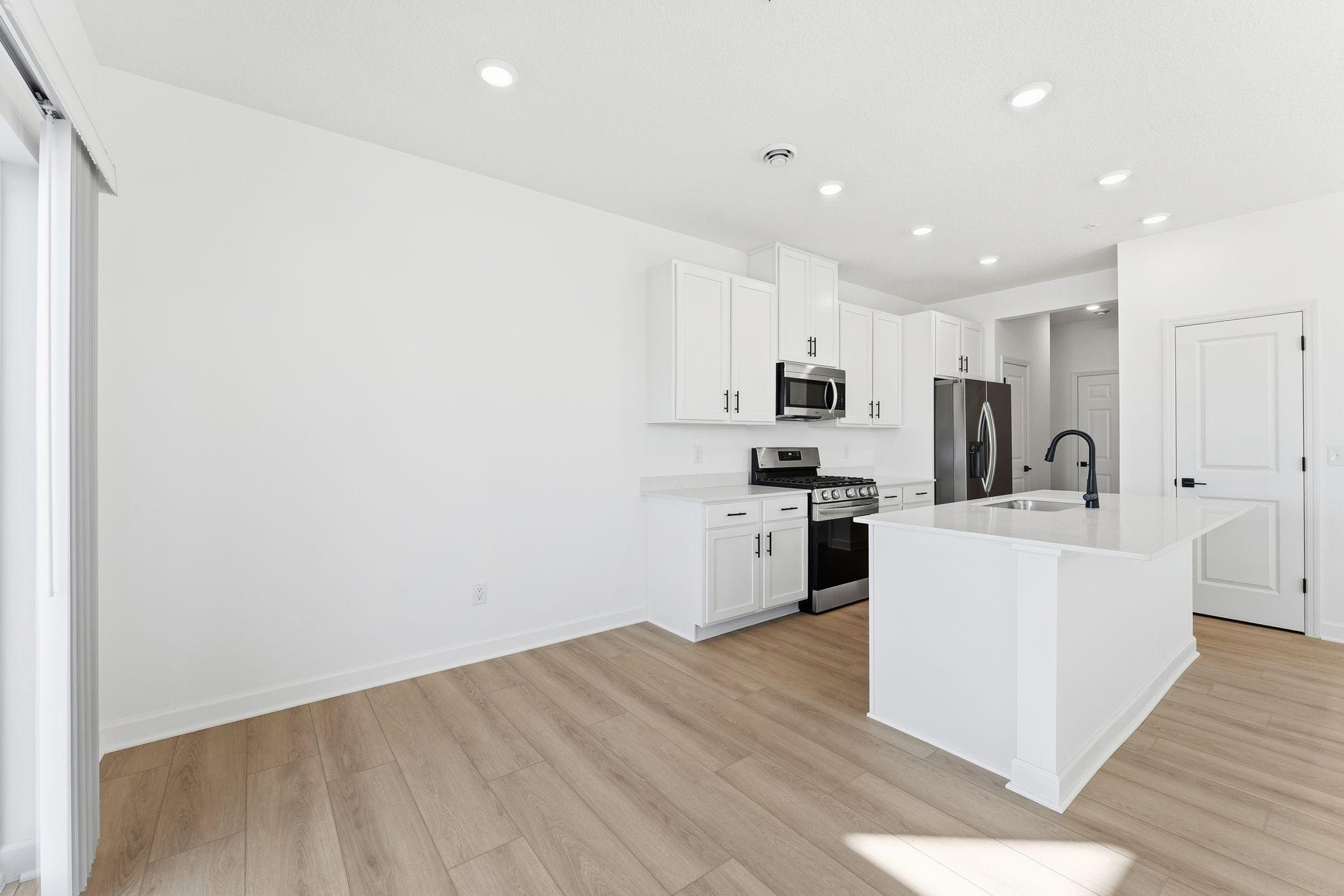 (Photo of a similar home, actual finishes may vary) Sharing a convenient layout with the kitchen, the dining room makes it a breeze to serve piping-hot meals straight off the stove and host delicious meals of all sizes on the dinner table.