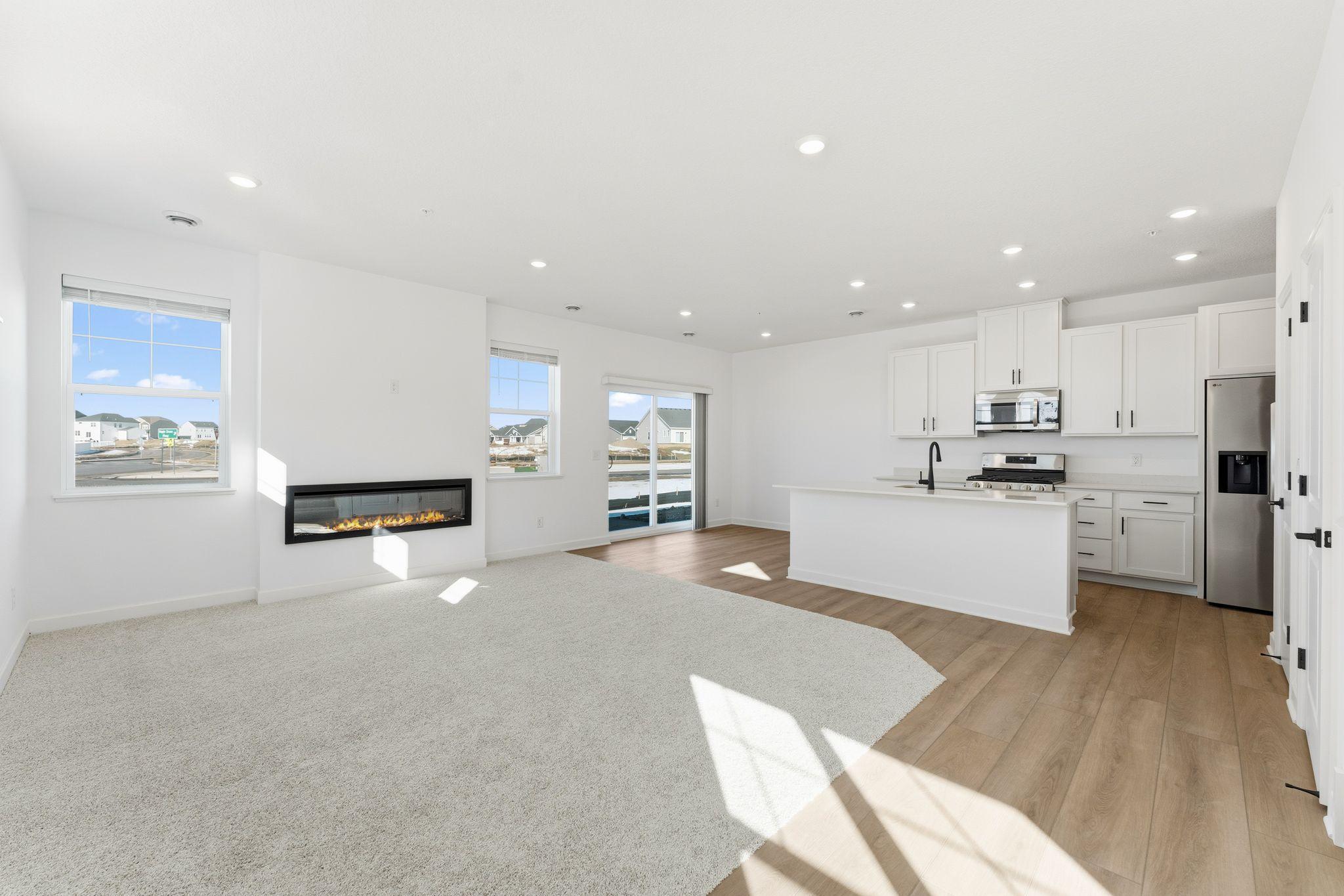 (Photo of a similar home, actual finishes may varyThe natural gathering space of the home, the Great Room is excellent for entertaining guests, hosting movie marathons and relaxing with loved ones, paired with the simplicity of a free-flowing design.