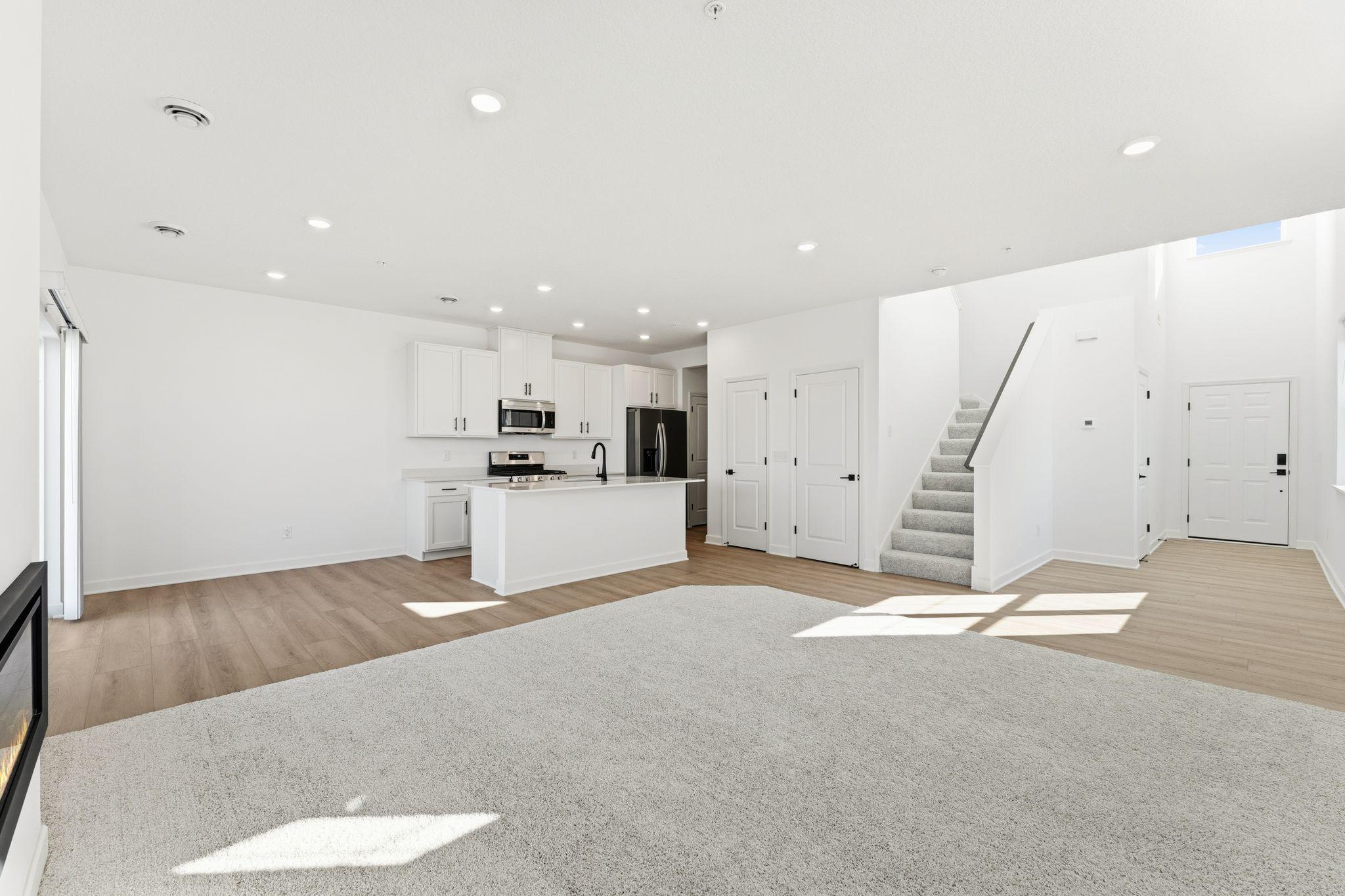 (Photo of a similar home, actual finishes may vary) This Great Room is framed by windows to bathe the space in natural light