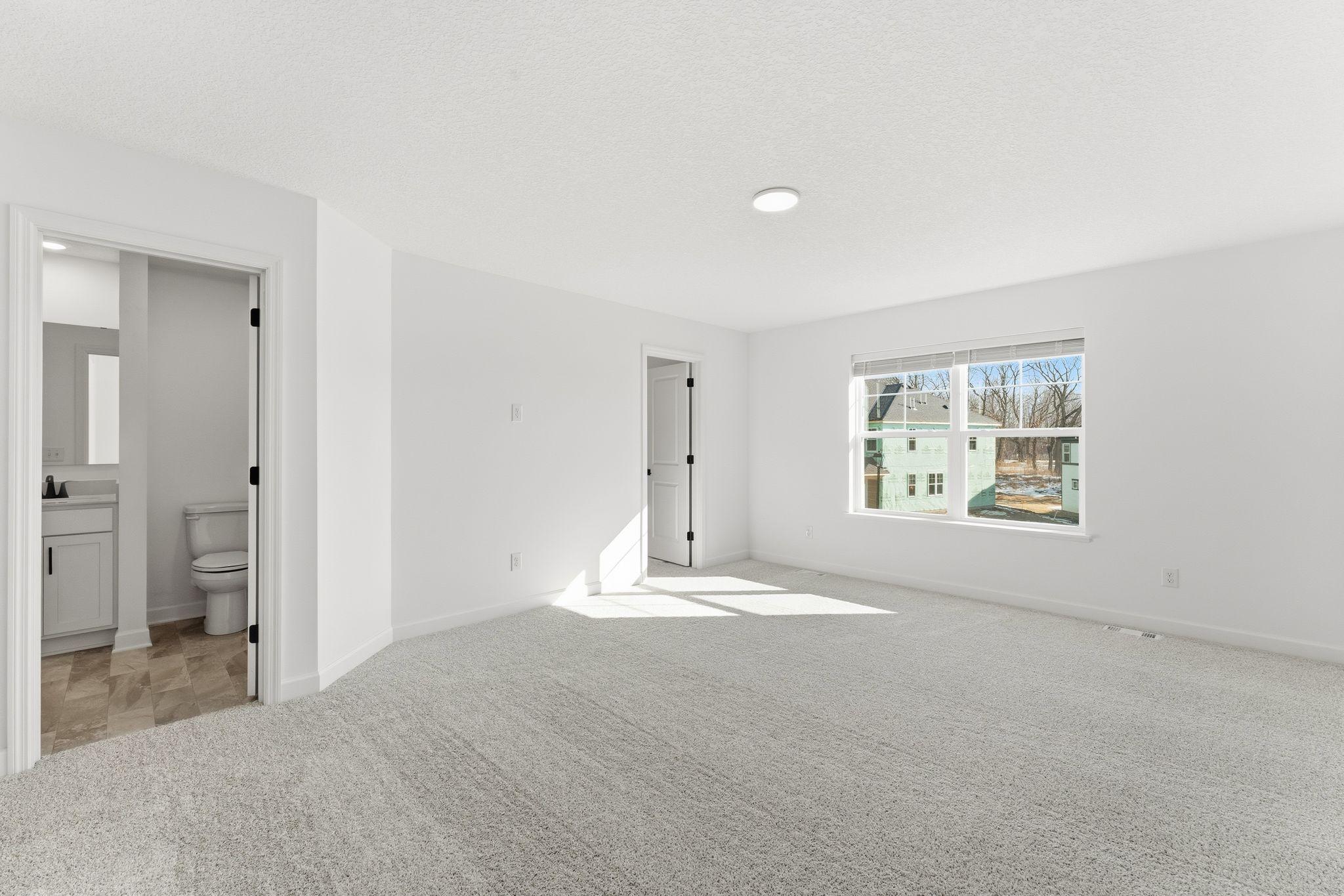 (Photo of a similar home, actual finishes may vNestled on the top floor, the private owner’s suite boasts a spacious bedroom to provide restful nights and a tranquil haven for relaxation, complemented by an en-suite bathroom and large walk-in closet.