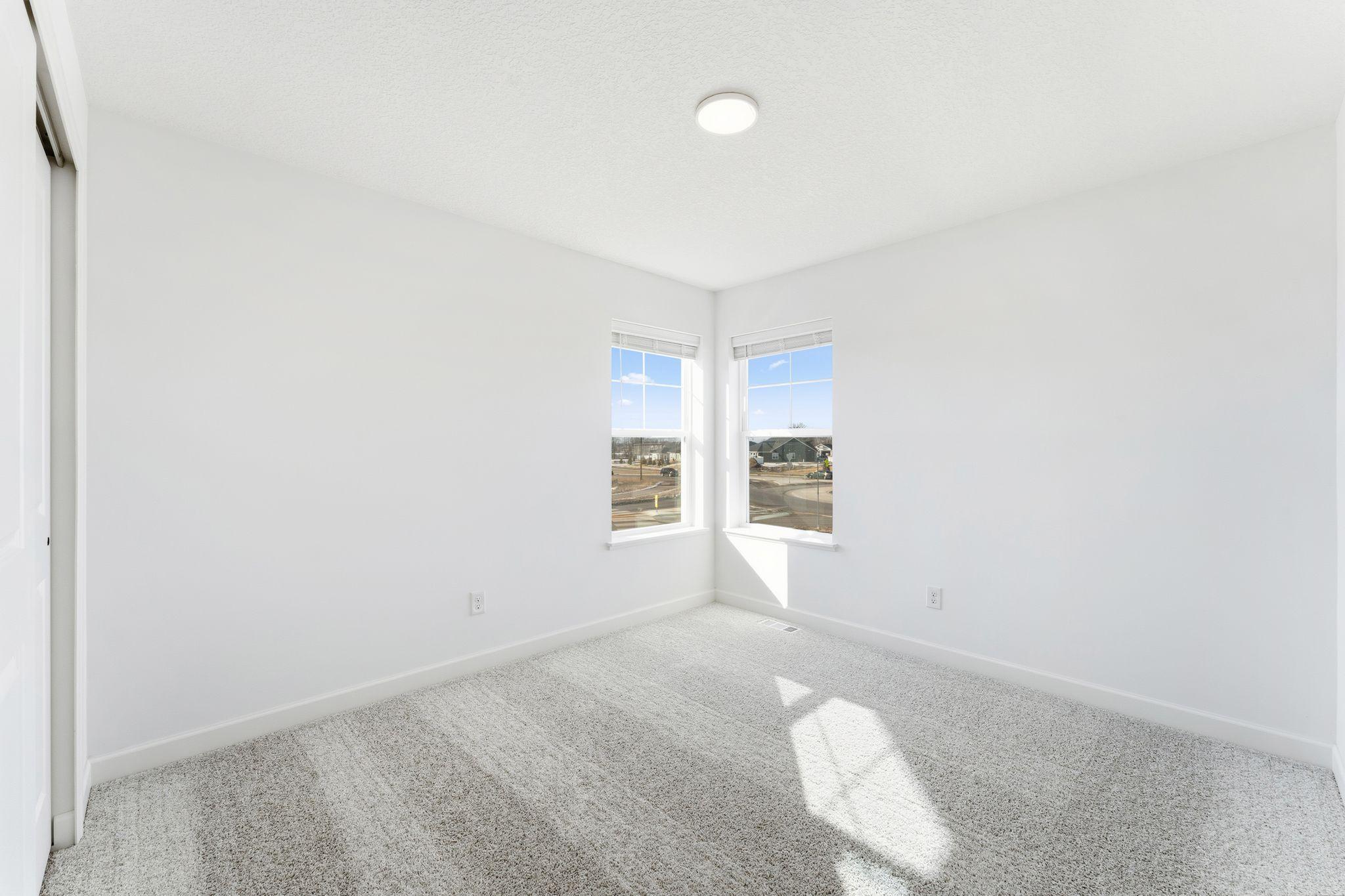 (Photo of a similar home, actual finishes may vary) The upper-level secondary bedrooms are perfectly situated away from the downstairs main living areas and are blank canvases ready to be personalized.