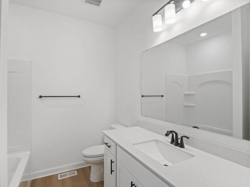 Situated just off the foyer, this full bathroom is easily accessed from each of the main-floor secondary bedrooms for family members or guests.