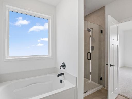 Designed for utmost versatility, the en-suite bathroom features a glass-enclosed shower for daily cleaning rituals and a corner tub perfect for indulgent soaks