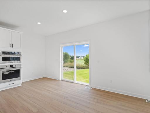 Situated in front of large glass-sliders, this dining room is washed in natural light and provides a place to serve piping-hot meals straight out of the oven.