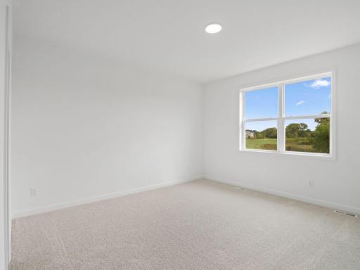 The owner’s suite is a restful retreat tucked away at the back of the home, complete with a spacious walk-in closet and a well-equipped bathroom designed for shared living.