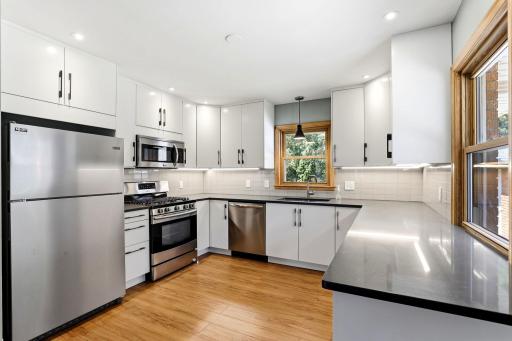 Remodeled kitchen with SS appliances, cabinets to ceiling