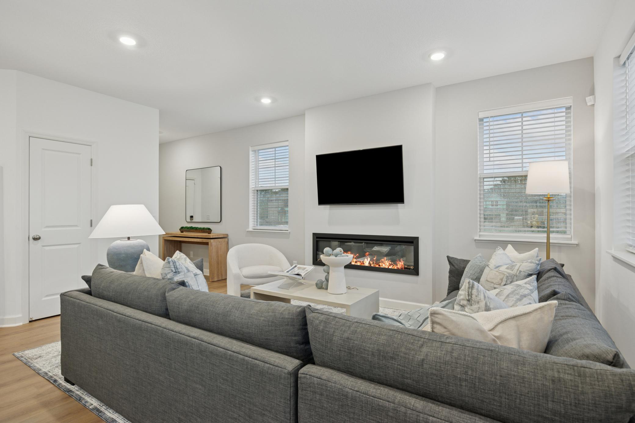 (Photo is of a model home, finishes will vary) The electric fireplace brings a warm glow to the space
