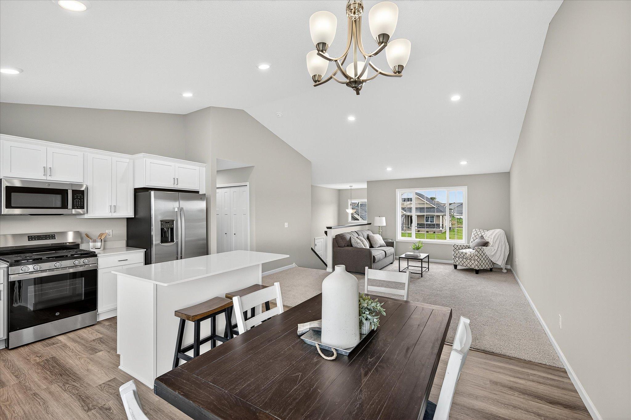 Open sightlines between the kitchen and living areas keep everyone connected whether you're cooking, hosting, or relaxing. *photos of a previously staged home, not all options & finishes may be exact.*