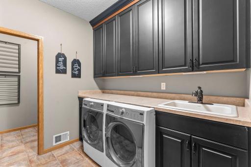 Large Laundry room with sink and cabinetry