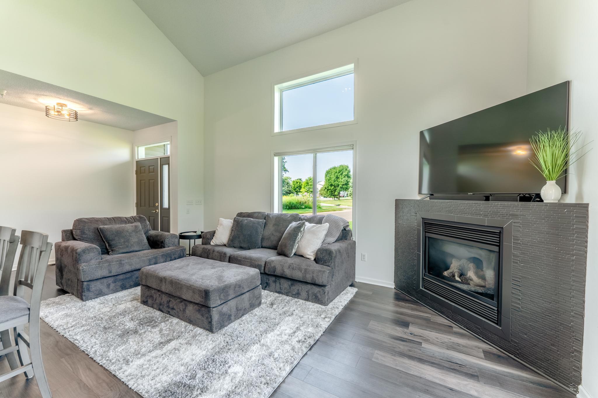 Living room is bright but has a gas fireplace keep things cozy when the weather turns cool.