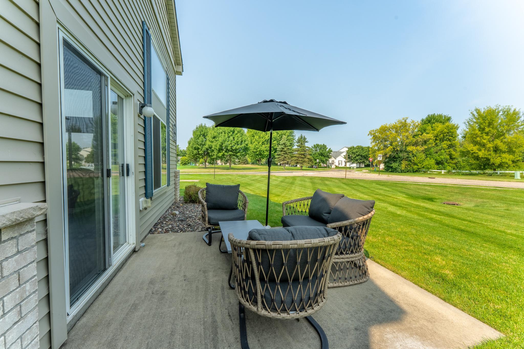 Patio with green space around it.