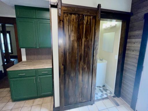 Main floor includes half bath with rolling door