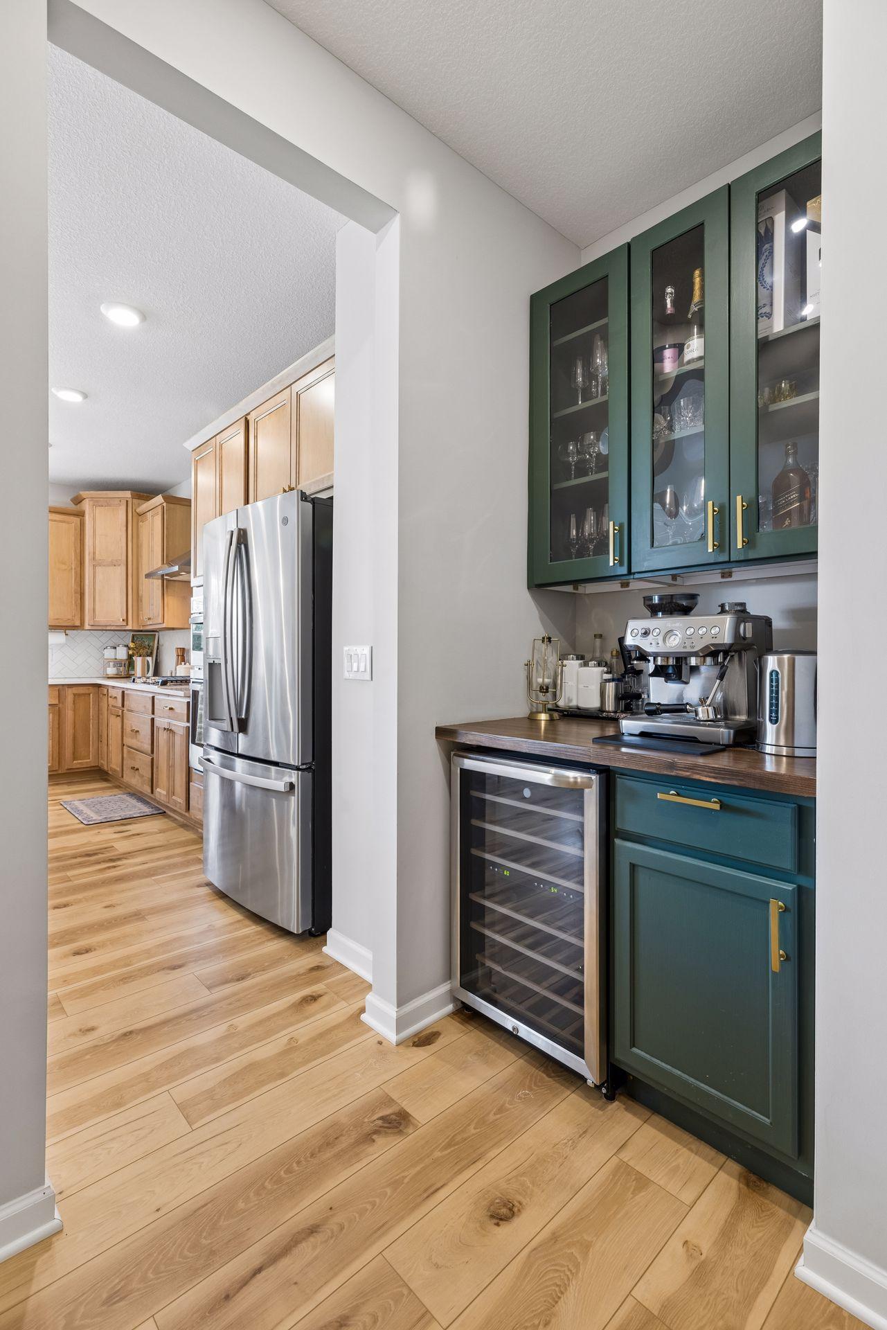 A walk-in pantry, dedicated coffee bar, and convenient connection to the mudroom and garage enhance daily living while maintaining a refined sense of style.