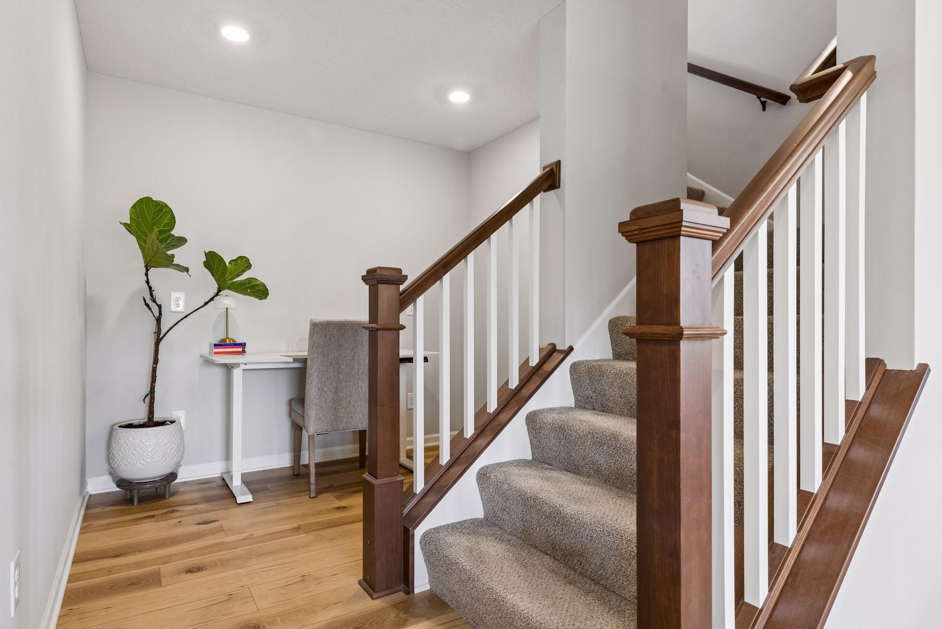 Ascending to the upper level, a thoughtfully positioned tech nook provides flexible space for homework, creative projects, or an informal office.