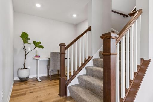 Ascending to the upper level, a thoughtfully positioned tech nook provides flexible space for homework, creative projects, or an informal office.