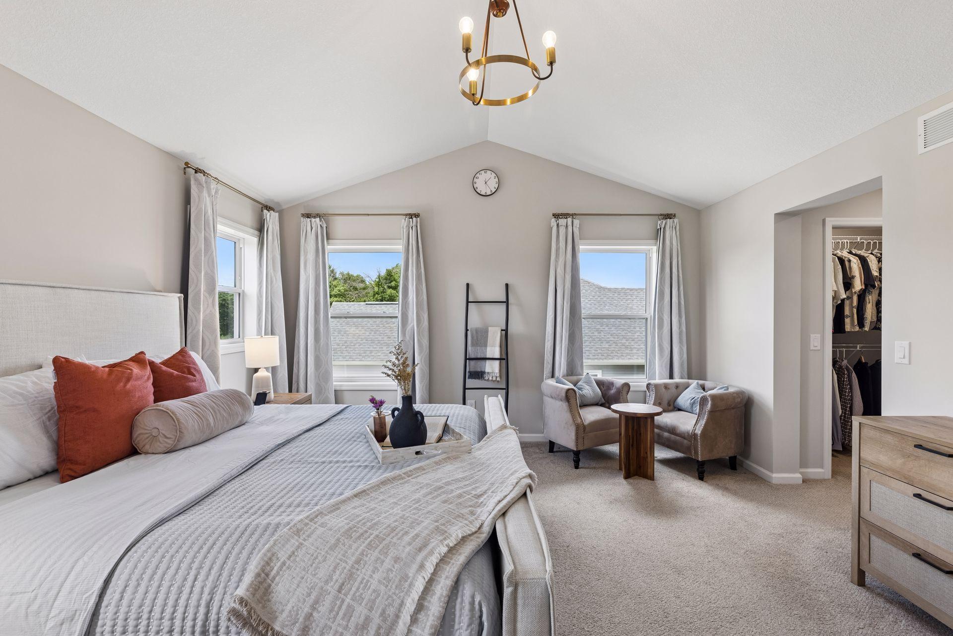 Privately situated overlooking the backyard, the primary suite enjoys serene views and a sense of separation from the rest of the home.