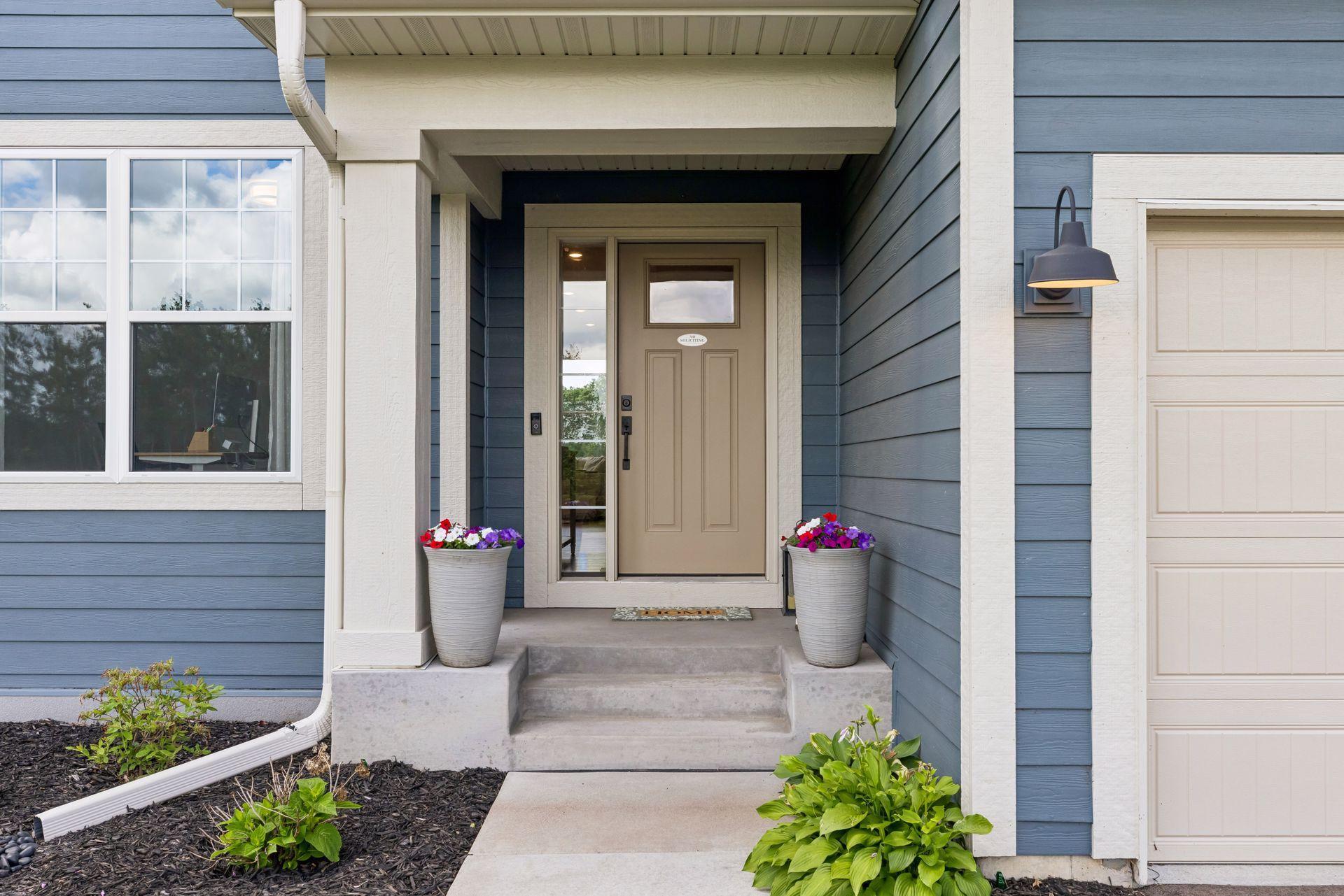 Framed by meticulous landscaping, the front entry introduces the care and craftsmanship found throughout the home.