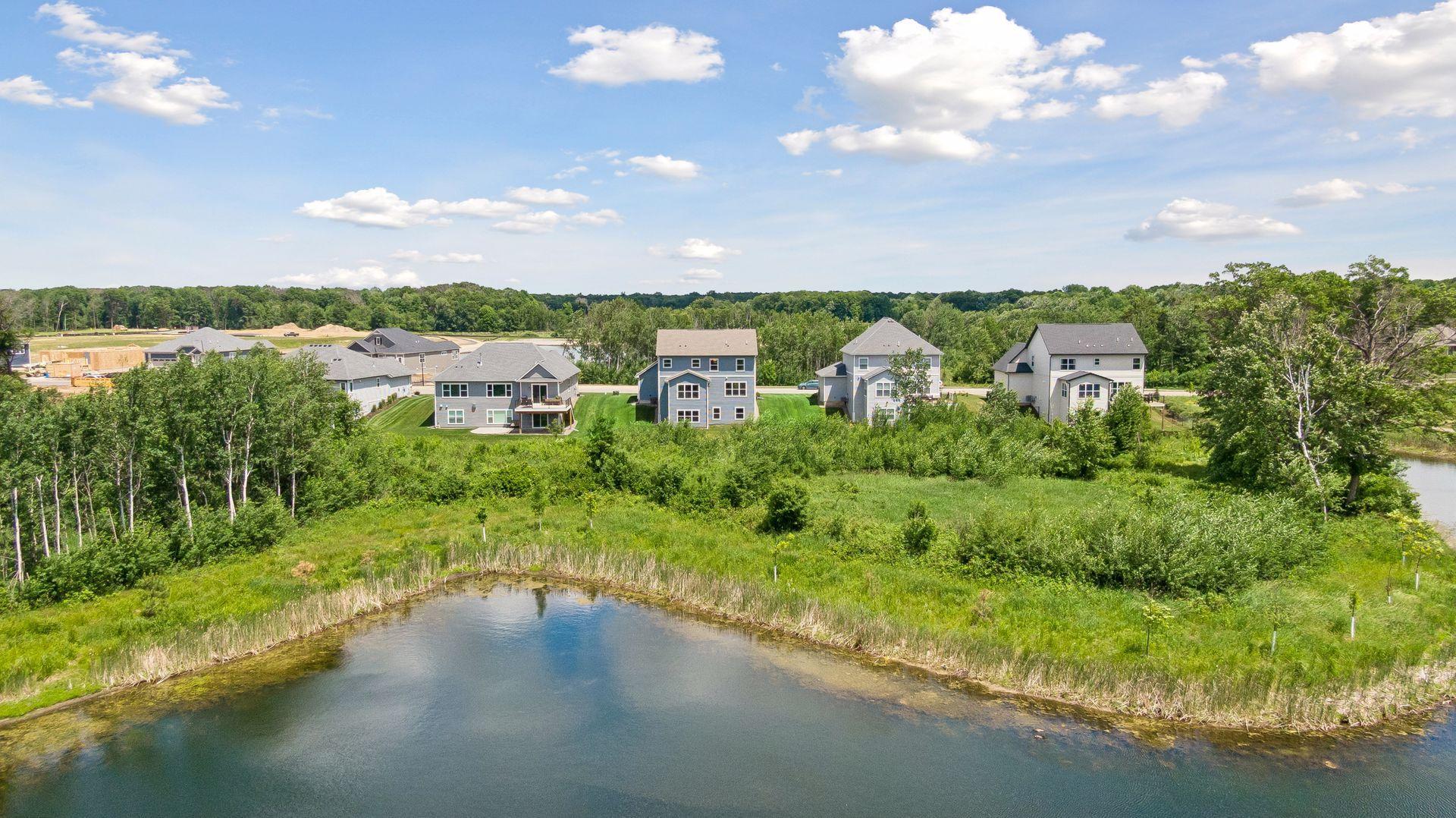 The backyard opens to a landscape of ponds, wetlands, and protected natural beauty, creating a backdrop that changes with the seasons.