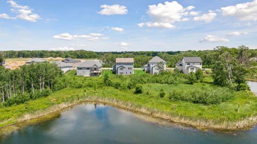 The backyard opens to a landscape of ponds, wetlands, and protected natural beauty, creating a backdrop that changes with the seasons.