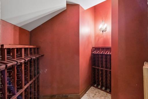 The wine storage room offers ample space for a large collection, with plenty of room for bottles.